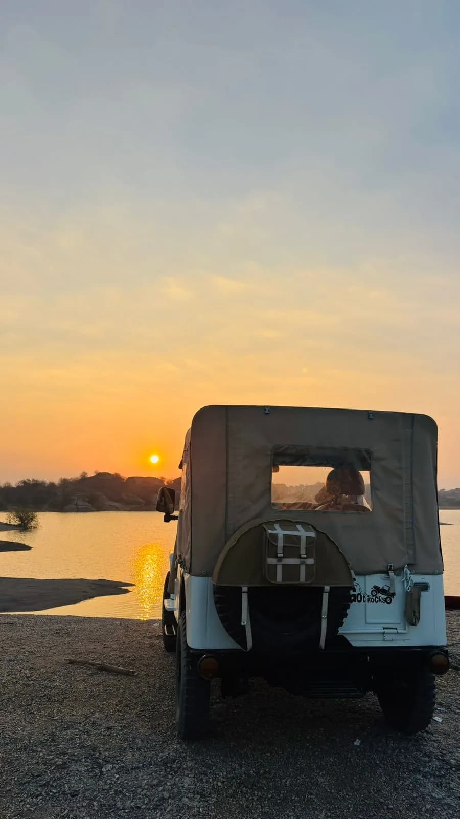 Open 4x4 safari vehicle during golden hour sunset near Jawai water